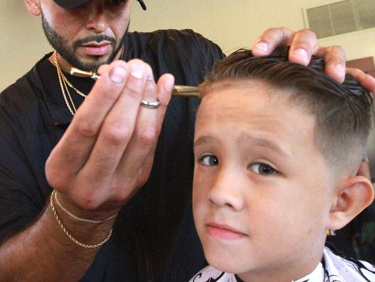 A cut above  Local stylists volunteer to give kids free haircuts