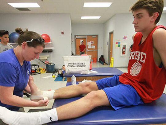 A TALE OF THE TAPE  Athletic trainers aim for safety among athletes