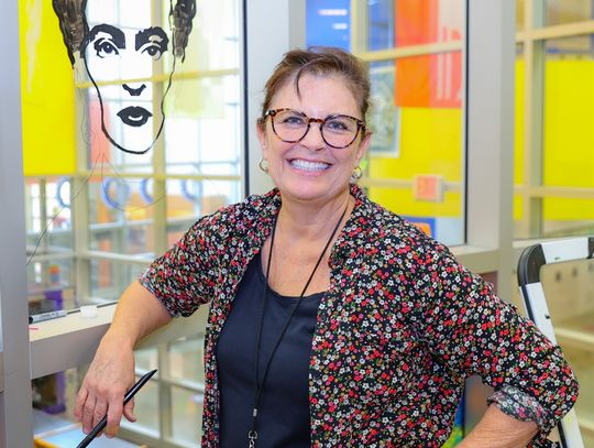 Teacher paints mural at Pfluger Elementary
