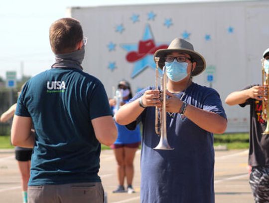 The band plays on: Hays High School Band, masks at ready, hits the practice field