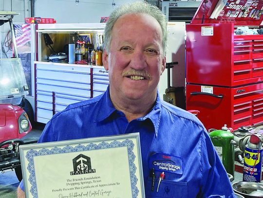 The Friends Foundation presents certificate to Central Garage